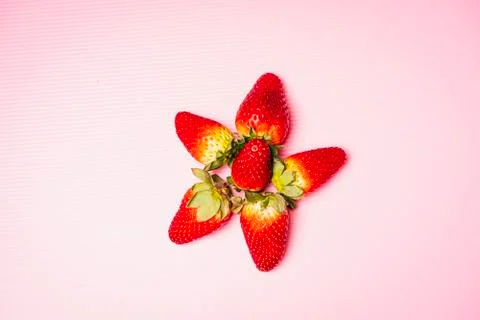 Flat lay composition of strawberries with pink background Stock Photos