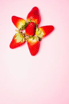 Flat lay composition of strawberries with pink background Stock Photos