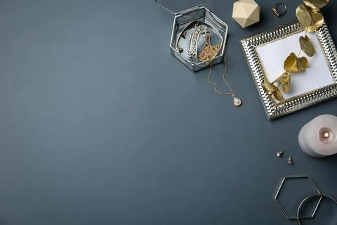 Flat lay composition with stylish accessories and decor elements on dark grey Stock Photos