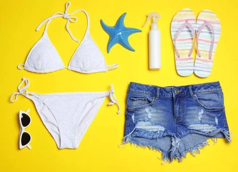 Flat lay composition with stylish bikini on color background. Beach objects Stock Photos