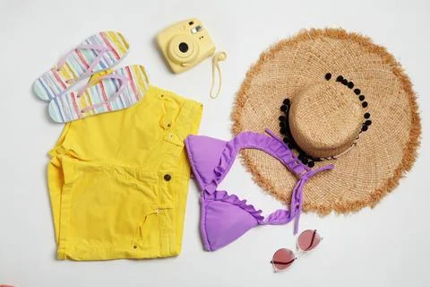 Flat lay composition with stylish bikini on white background. Beach objects Fotos de archivo