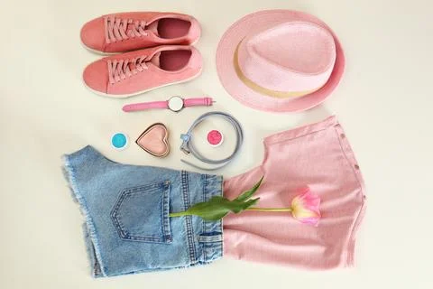Flat lay composition with stylish summer clothes and accessories on light bac Stock Photos