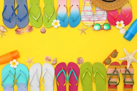 Flat lay composition with summer beach accessories on yellow background. Spac 스톡 사진