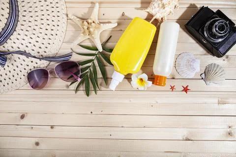 Flat lay composition with sunscreen, glasses, camera and seashells Stock Photos