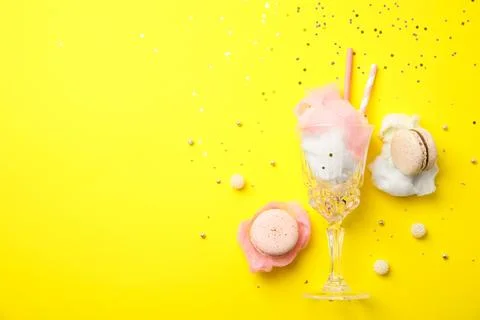Flat lay composition with sweet cotton candy on yellow background, space for  스톡 사진