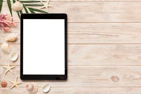 Flat lay composition with tablet and beach accessories on colored background. Stock Photos