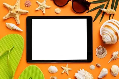 Flat lay composition with tablet and beach accessories on colored backgroun.. Stock Photos