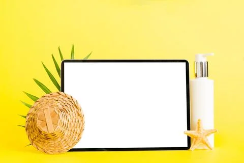 Flat lay composition with tablet and beach accessories on colored background. Stock Photos