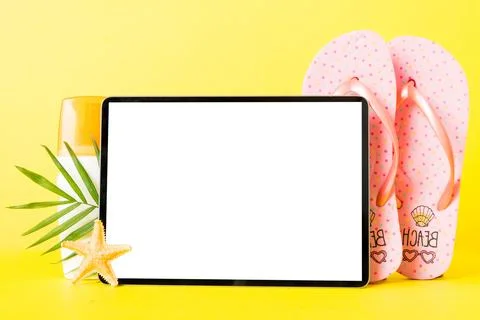 Flat lay composition with tablet and beach accessories on colored backgroun.. Stock Photos