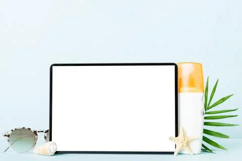 Flat lay composition with tablet and beach accessories on colored background. Stock Photos