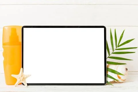 Flat lay composition with tablet and beach accessories on colored background. Stock Photos