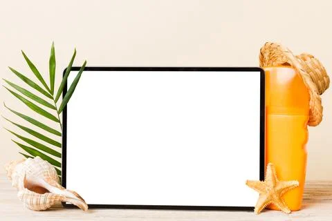 Flat lay composition with tablet and beach accessories on colored background. Stock Photos