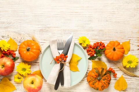 Flat lay composition with tableware, autumn fruits and vegetables on white wo Stock Photos