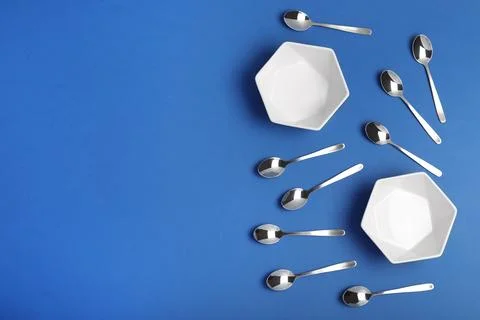 Flat lay composition with tableware on blue background, space for text Stock Photos
