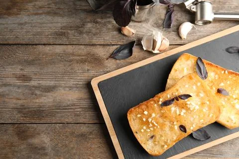 Flat lay composition with tasty garlic and space for text bread on table Stock Photos