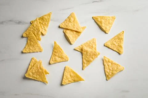 Flat lay composition of tasty tortilla chips (nachos) on white table 写真素材