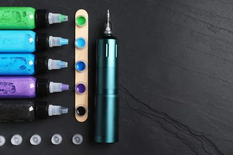 Flat lay composition with tattoo equipment on black table. Space for text Foto stock