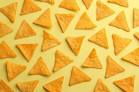 Flat lay composition of tortilla chips (nachos) on yellow background 库存照片