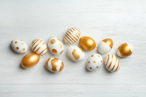 Flat lay composition of traditional Easter eggs decorated with golden paint o Stock Photos