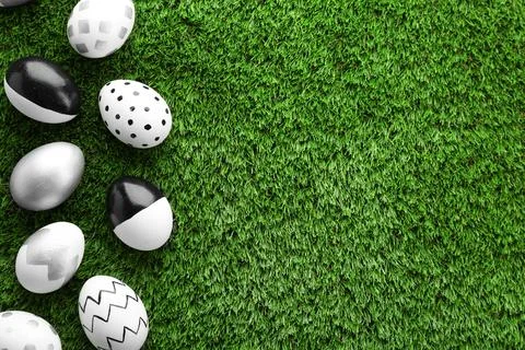 Flat lay composition of traditional Easter eggs on green lawn, space for text 写真素材
