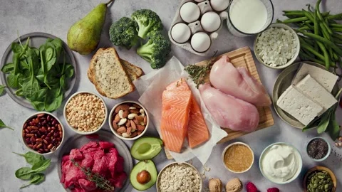 Flat lay composition of various fresh protein diet products on grey backgroun Stock Footage 317263643