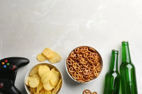 Flat lay composition with video game controller, snacks and space for text on Stock Photos