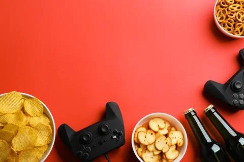 Flat lay composition with video game controllers, snacks and space for text o Stock Photos