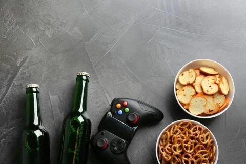 Flat lay composition with video game controller, snacks and space for text on Stock Photos