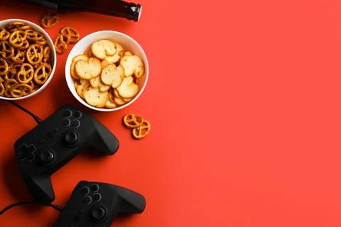 Flat lay composition with video game controllers, snacks and space for text o Stock Photos