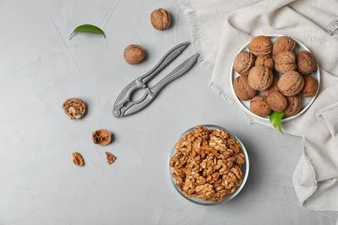 Flat lay composition with walnuts on grey background Stock Photos