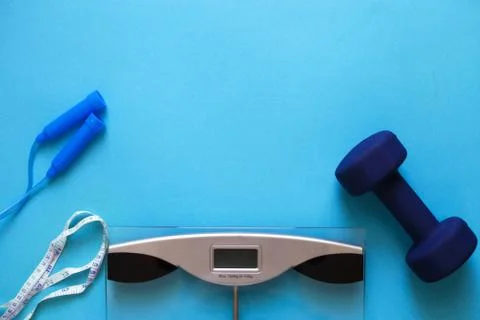 Flat lay composition with weigh scales, skipping rope and dumbbells isolated  Fotos Stock
