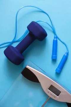 Flat lay composition with weigh scales, skipping rope and dumbbells isolated  Photos
