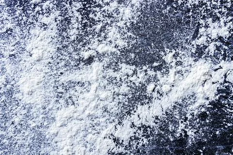 Flat lay composition of white wheat baking flour sprinkled on a back textured Stock Photos