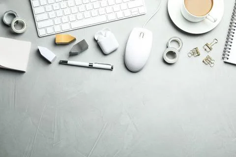 Flat lay composition with wired computer mouse and stationery on light grey t Stock Photos