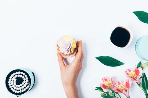 Flat lay composition woman's hand holding cupcake 스톡 사진