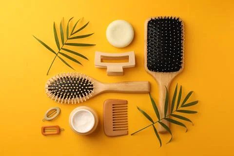 Flat lay composition with wooden brushes and different hair products on ora.. Foto stock