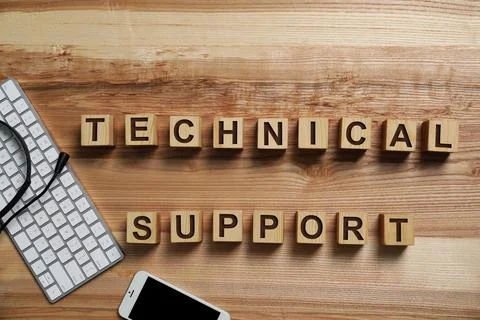 Flat lay composition with words TECHNICAL SUPPORT and computer keyboard on wo Stock Photos