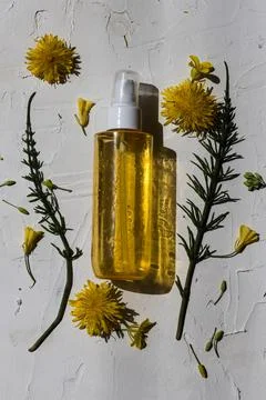 Flat lay composition of a yellow bottle on white background Stock Photos