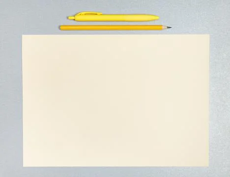 Flat lay composition of yellow pen, pencil and sheet of paper on a gray surfa Stock Photos