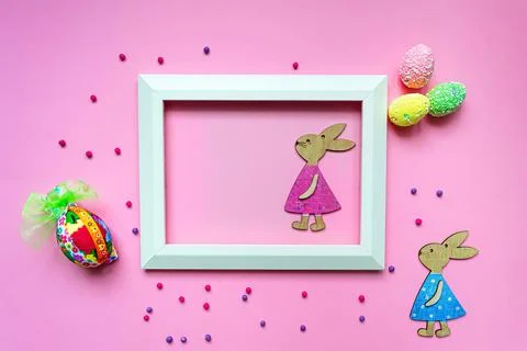 Flat lay concept of Easter holiday. Top view pink background, bunnies and egg Stock Photos