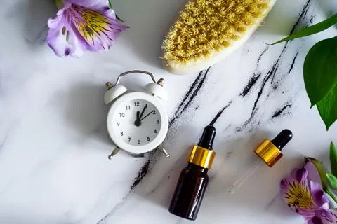 Flat lay concept of time taking care of body and face. Cosmetics and brush Stock Photos