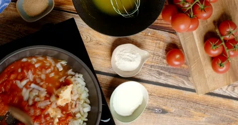 Flat lay cooking: chef cooks vegetable stew with onion and tomatoes Stock Footage 219478975