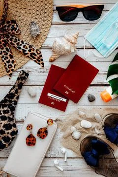 Flat lay with copy space of beach accessories with face mask and alcohol hand Stock Photos