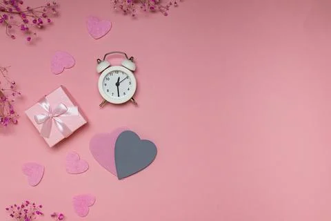 Flat lay with copy space for valentine's day: gift, alarm clock and hearts on Stock Photos