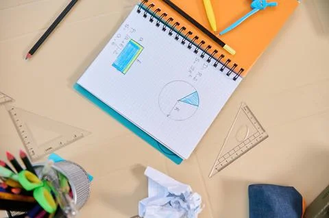 Flat lay of a copybook with geometry examples for solving in primary school Stock Photos