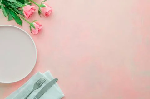 Flat lay corner restaurant table for romantic dinner with pink rose flowers Stock Photos