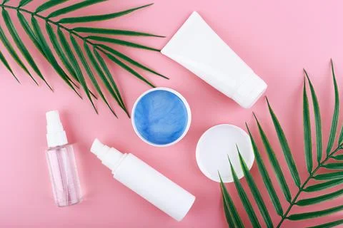 Flat lay with cosmetic set: cleansing foam, cream, opened jar with face mask on Stock Photos