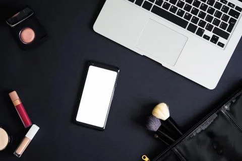 Flat lay of cosmetics, make up equipment, laptop and mobile phone. Foto stock