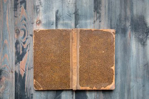Flat lay of covered ancient book on vintage hoary background. Copy space Stock Photos