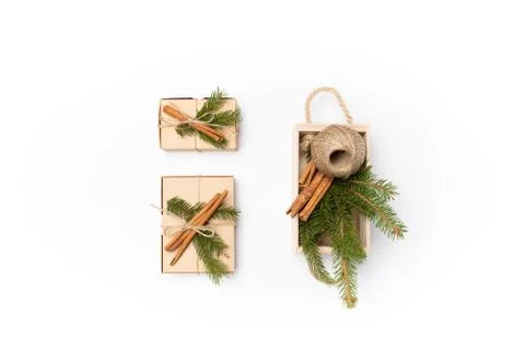 Flat lay craft boxes and wooden box with pine tree, rope and cinnamon on white Stock Photos